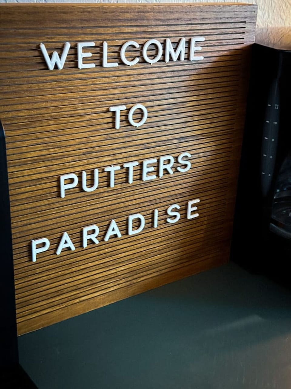 This charming letter board adds a personalized and welcoming touch, instantly conveying a playful and inviting atmosphere to guests. It highlights a unique theme, suggesting a home perfect for golf enthusiasts or those seeking a fun, leisure-oriented
