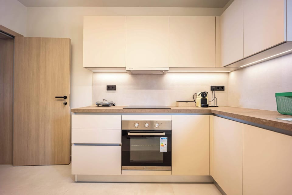 Bright kitchen with sleek finishes, perfect for preparing meals before exploring Athens’ vibrant nearby attractions.