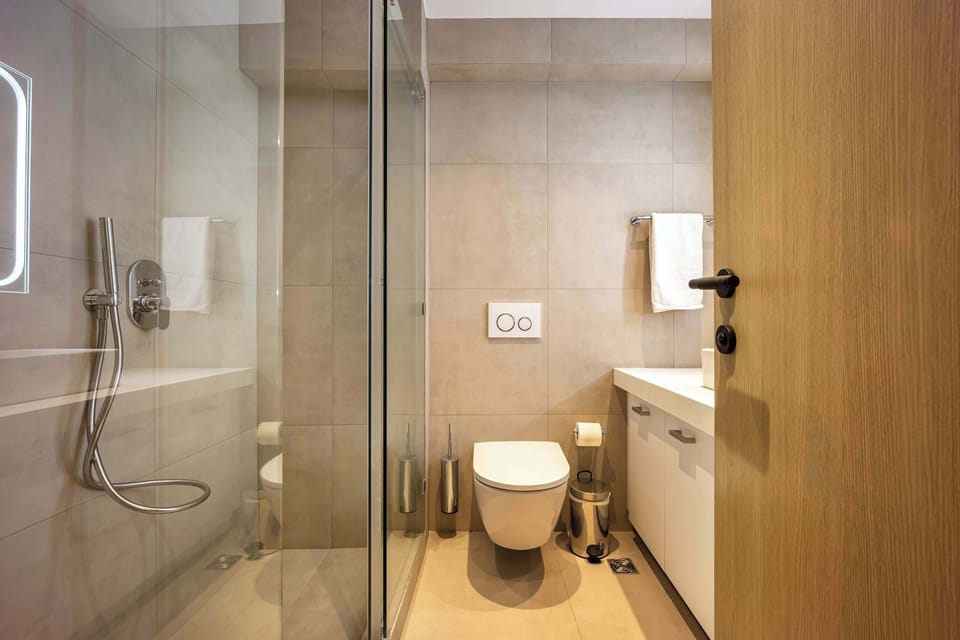 Modern bathroom with efficient layout, elegant finishes, and refreshing shower for daily Athens comfor
