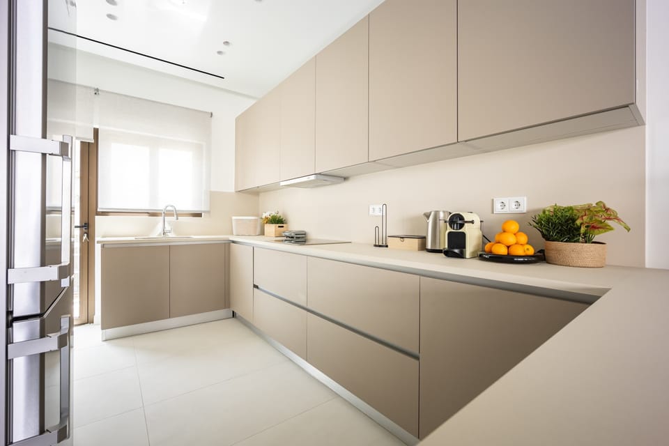 Sunny kitchen with sleek cabinetry, admired as spotless, brand new, and perfect for morning rituals.

