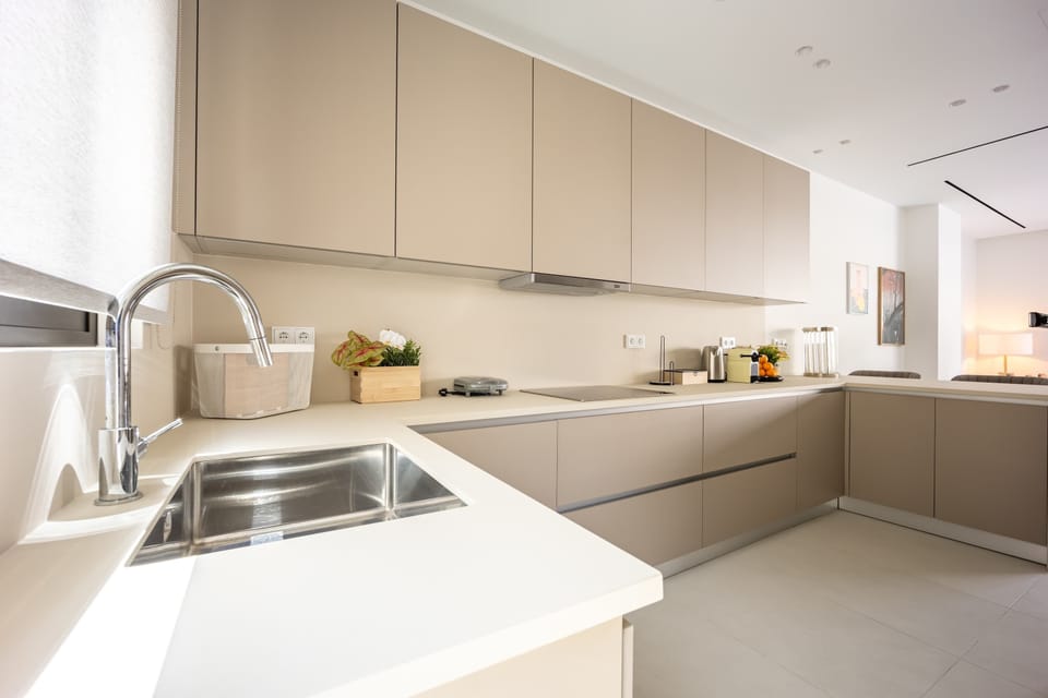 Streamlined kitchen praised for functionality, designed for effortless cooking and enjoyable dining during Athens stays.

