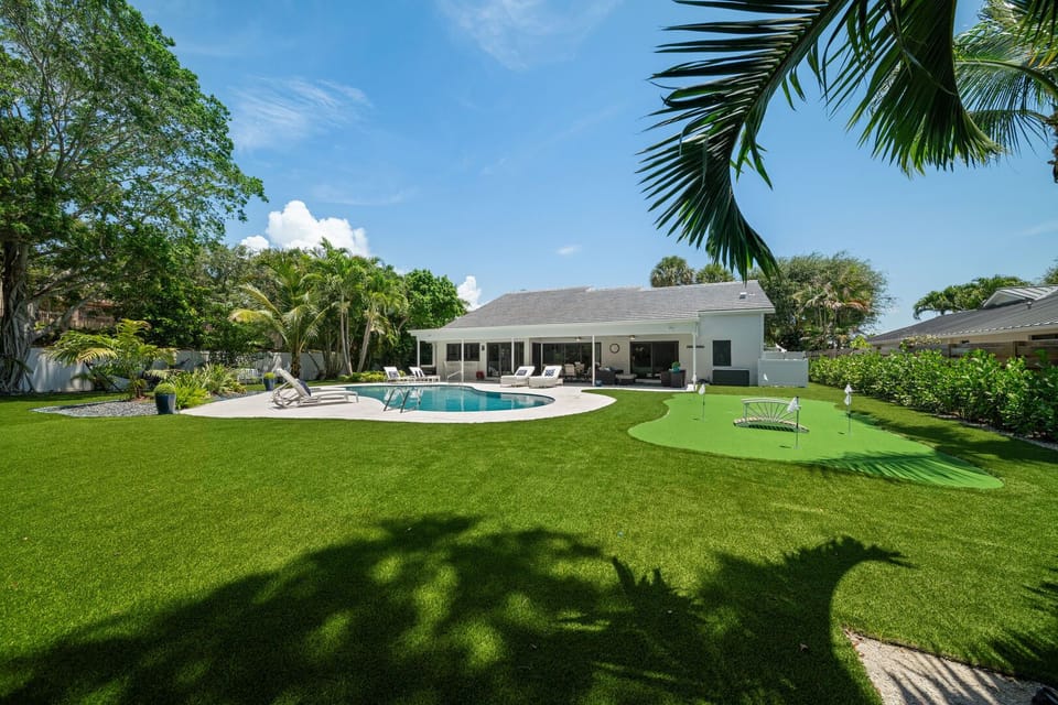 Artificial turf throughout the oversized back yard, with putting green, fire pit, hammock area
