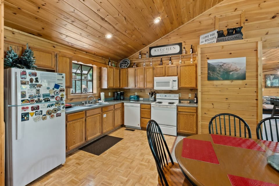 Prepare your favorite meals in this fully equipped kitchen, where warm wood cabinetry, cheerful décor, and all the essentials make you feel right at home.