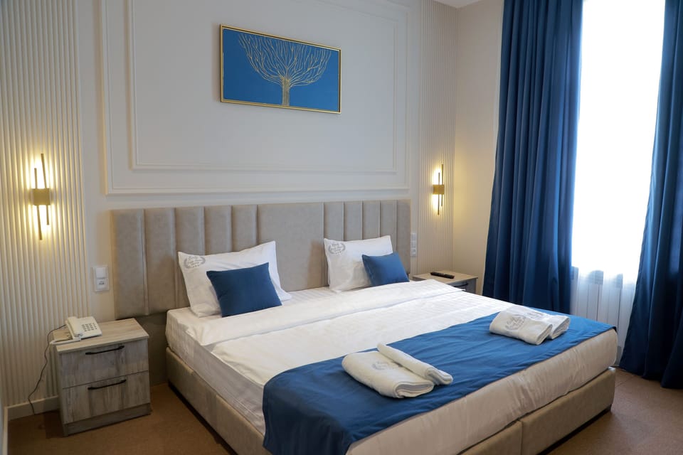 Comfort Double Room, City View | In-room safe, desk, laptop workspace, blackout drapes