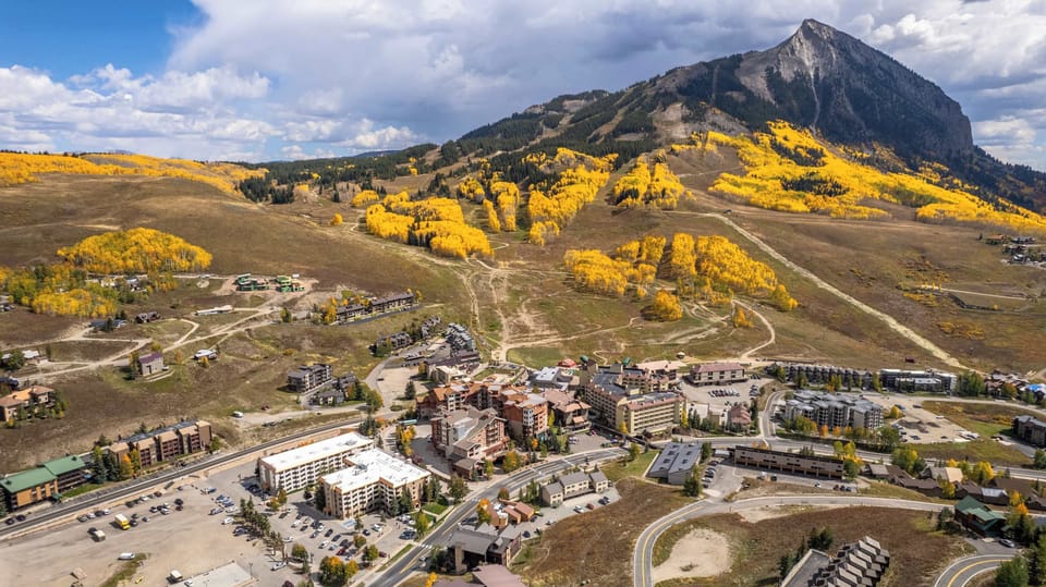 Sunset over the Fall Foliage featuring The Grand Lodge & Mt. Crested Butte | Listed with @BookTraverse