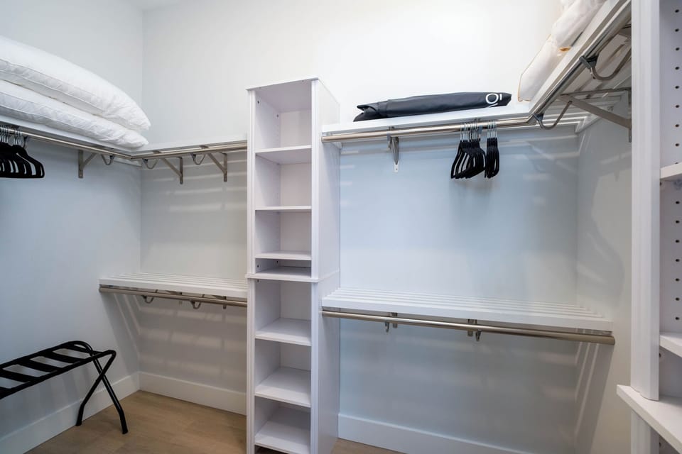 Spacious walk-in closet with custom shelving and ample storage