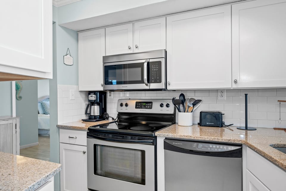 Your fully equipped kitchen awaits with stainless steel appliances and granite counters, perfect for morning coffee or preparing meals during your stay.