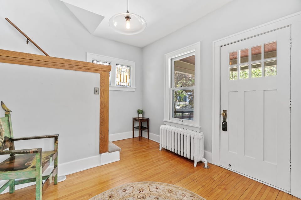Step into your welcoming entryway with gleaming hardwood floors, charming period details, and natural light streaming through original windows.