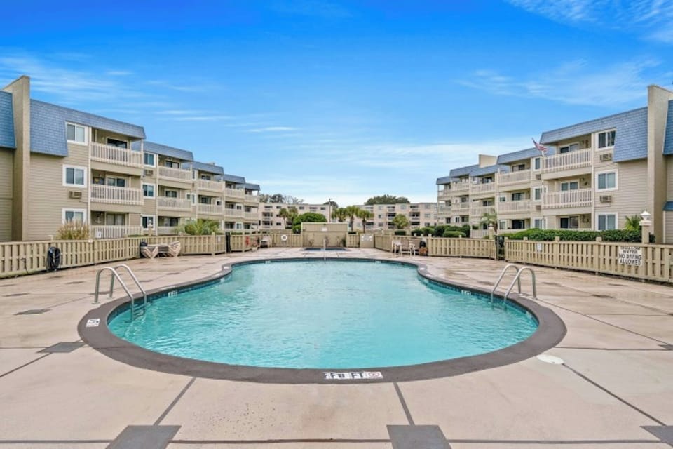 Take a cool dip in the sparkling pool after a fun day at the beach.