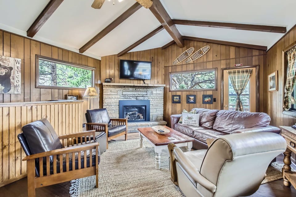 One Particlular Cabin Living Room with Sofa Three Chairs and TV