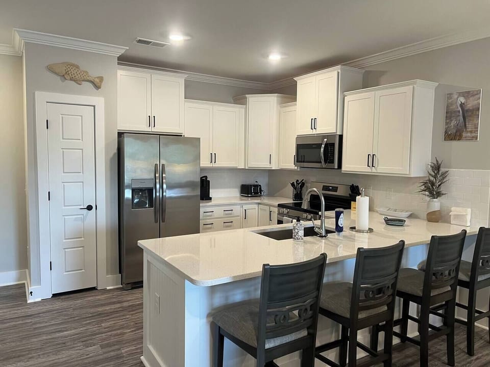 Kitchen with full size counter with stools