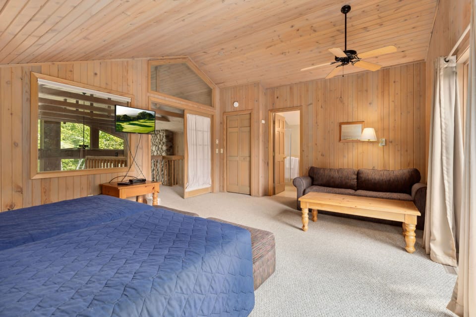 Spacious bedroom featuring a relaxing seating area.