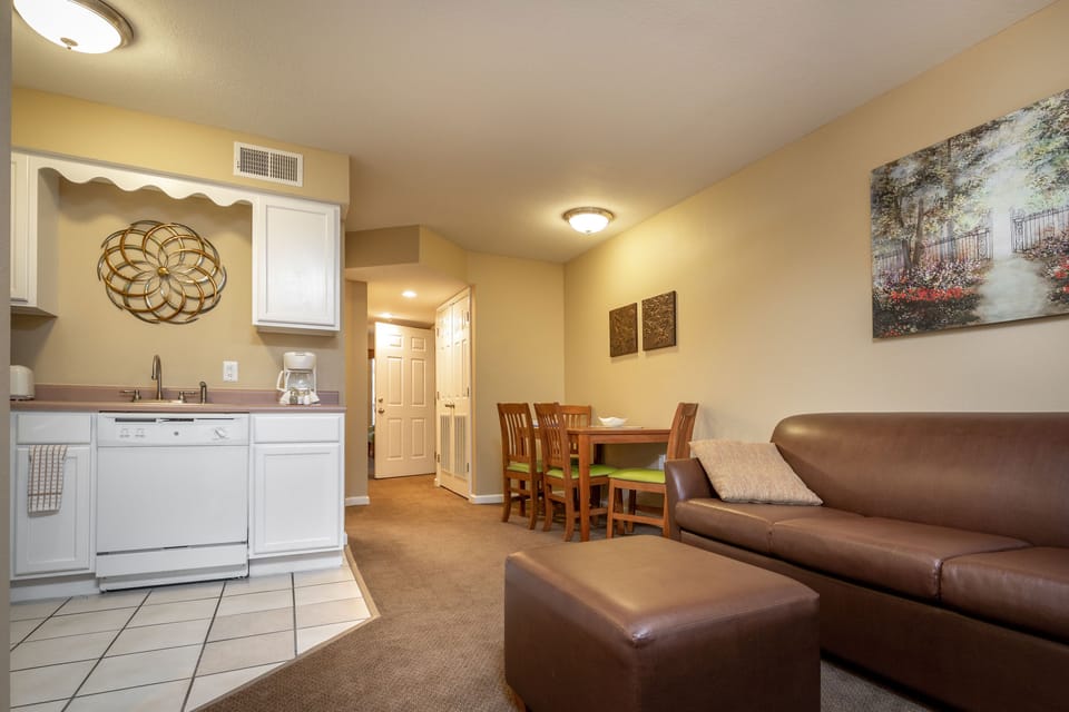 Bright kitchen with full-size fridge, microwave, toaster, and all the cooking basics you need