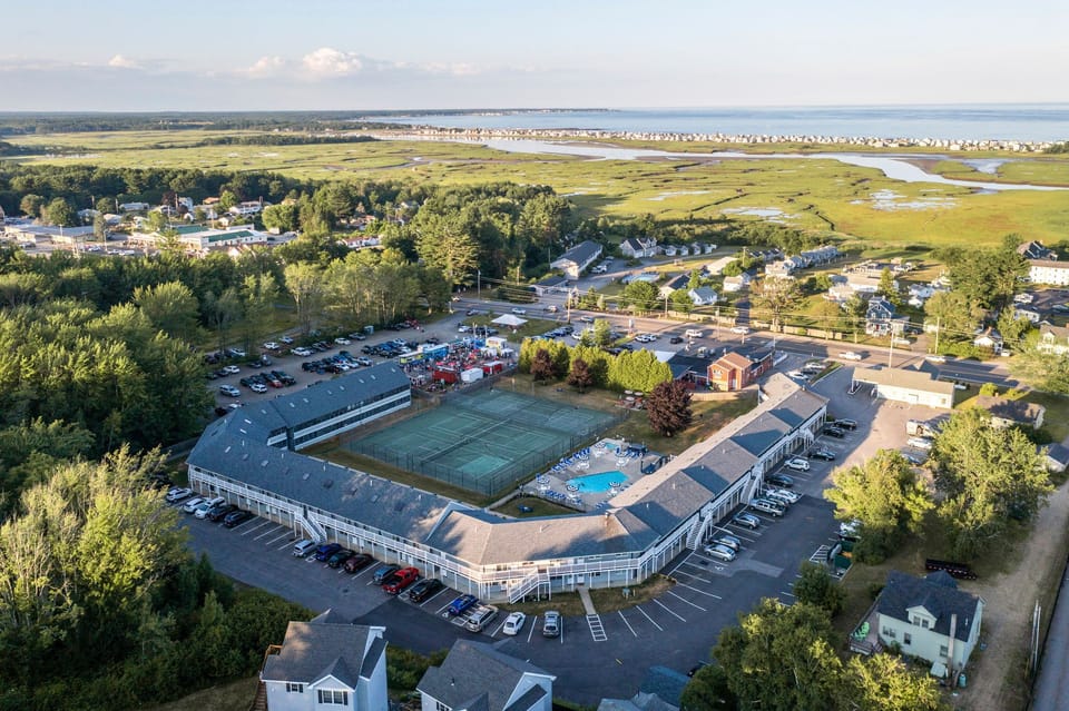 Bird’s-eye view of the property grounds and surrounding green spaces — get a full sense of this peaceful retreat.