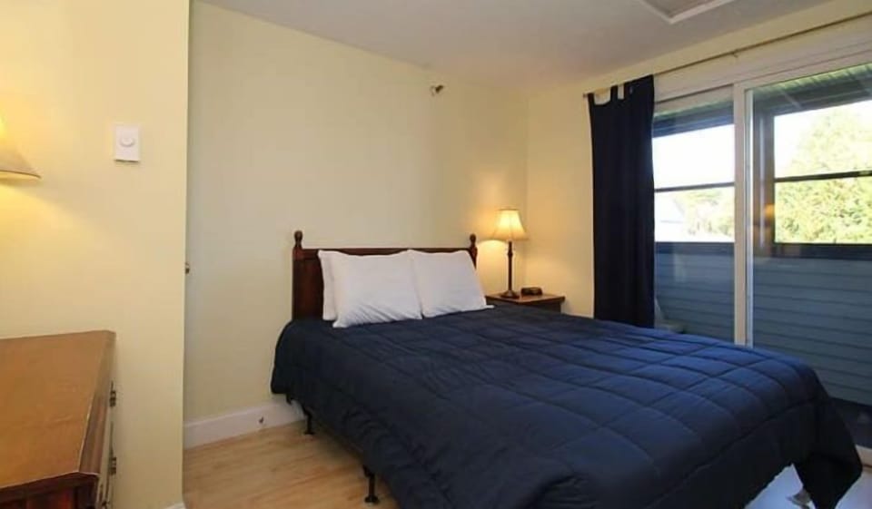 Comfortable bedroom with ample natural light and easy outdoor access.