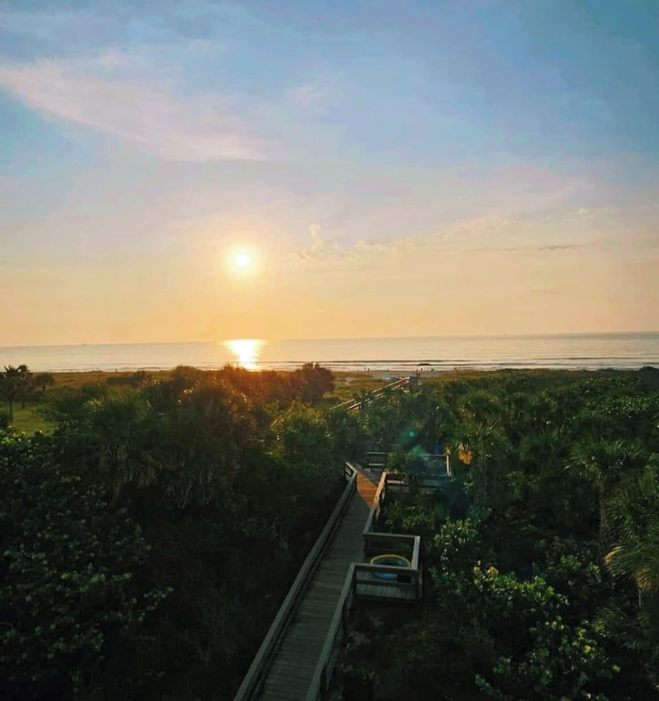 Experience breathtaking sunsets over the ocean, just a stroll away from sandy beach access.