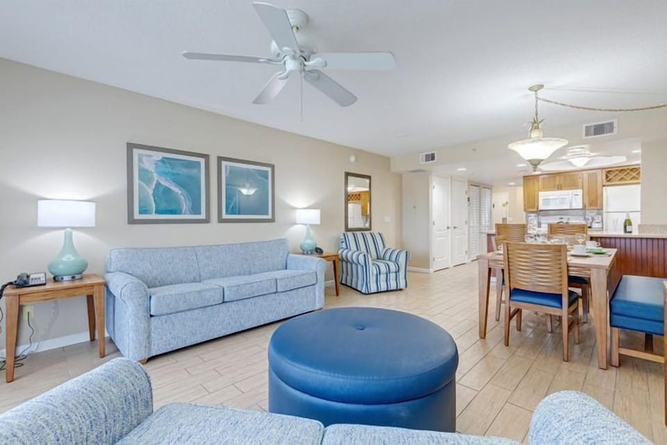 Embrace a serene environment in this open-plan living area, where stylish decor meets functionality, connecting seamlessly with the kitchen and dining space for family bonding and relaxation.