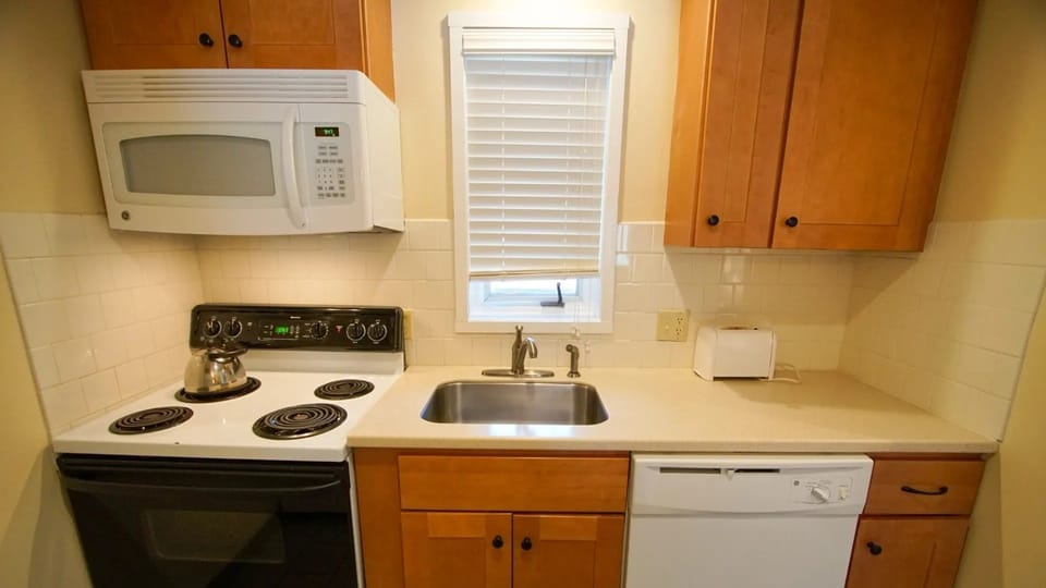 This well-equipped kitchen, featuring modern appliances and ample counter space, offers the perfect environment for preparing meals during your stay.