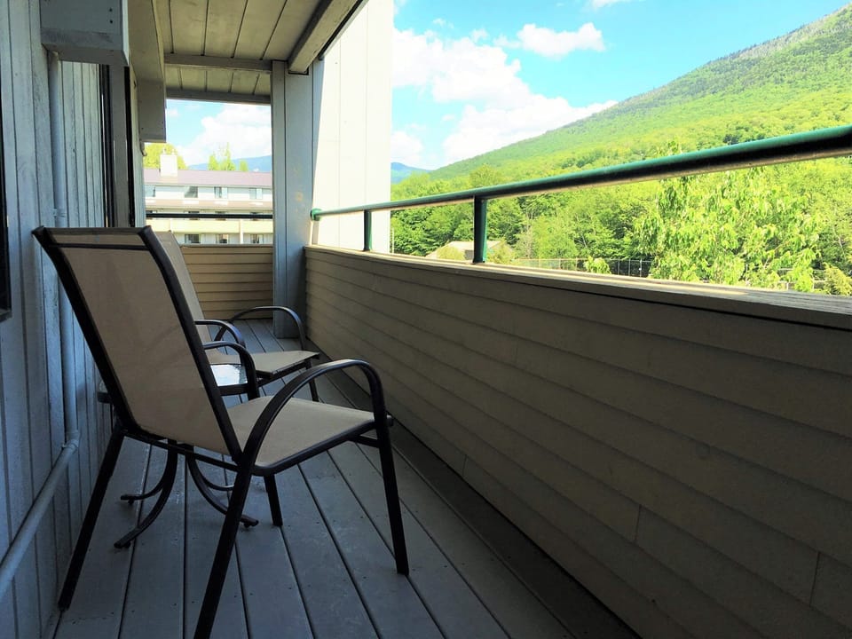 Enjoy your morning coffee or an evening glass of wine on the private balcony, which offers tranquil vistas of the mountains and lush greenery surrounding the cabin.