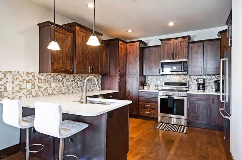 Large kitchen with a Keurig, toaster, blender, waffle maker.