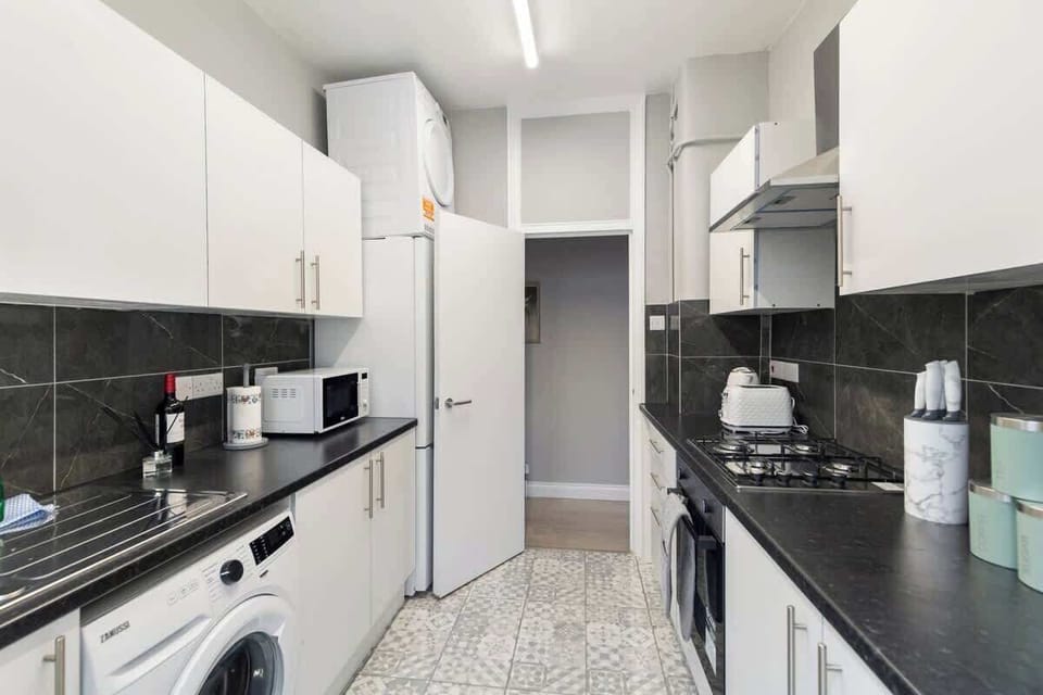 - Spacious kitchen with modern appliances and storage  
- Features fridge, oven, stove, and counter space  
- Practical layout designed for home-style cooking