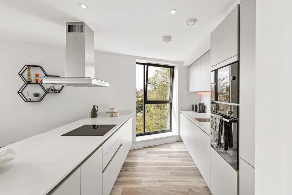 - Sleek modern kitchen with built in appliances and minimalist design  
- Large window brings in sunlight to brighten your cooking space  
- Perfect Airbnb setup for preparing meals with family and friends