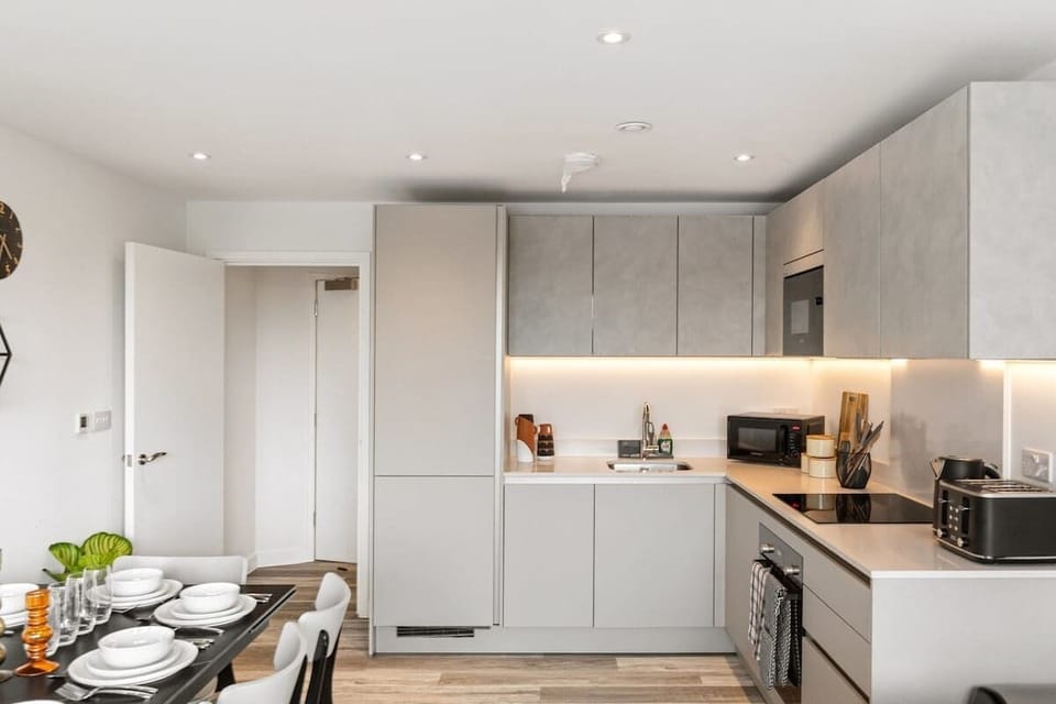- Stylish modern kitchen with sleek cabinetry and built-in oven  
- Fully equipped space with microwave fridge and essentials  
- Ideal for extended Airbnb stays and convenient home cooking  