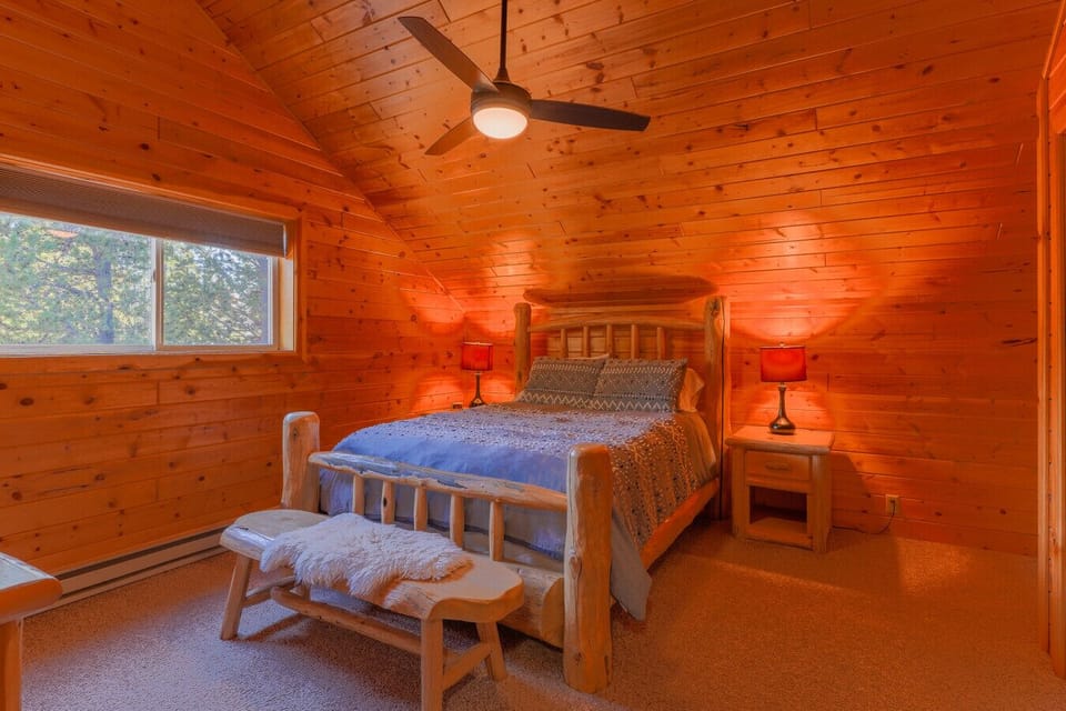 Upstairs bedroom with a queen bed and upper loft area for kids