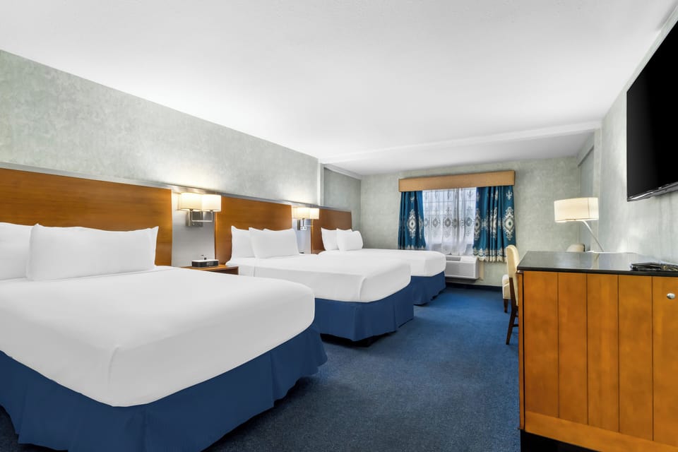 Family Room | Premium bedding, desk, laptop workspace, blackout drapes