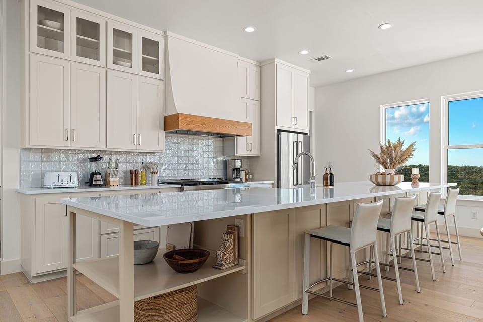 Whip up feasts or sip morning coffee—this chef’s kitchen blends high-end appliances with space made for connection. 