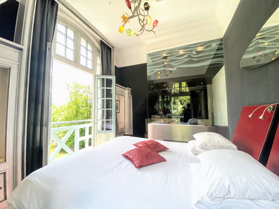 Junior Suite, River View | Minibar, in-room safe, desk, iron/ironing board