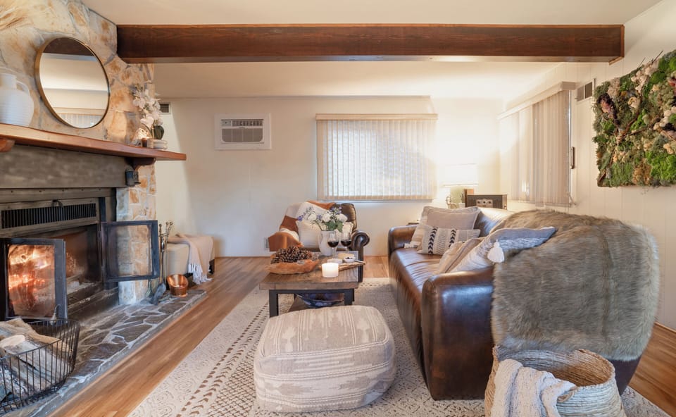 Cozy up by the fireplace while relaxing  on the leather sofa, and enjoying music