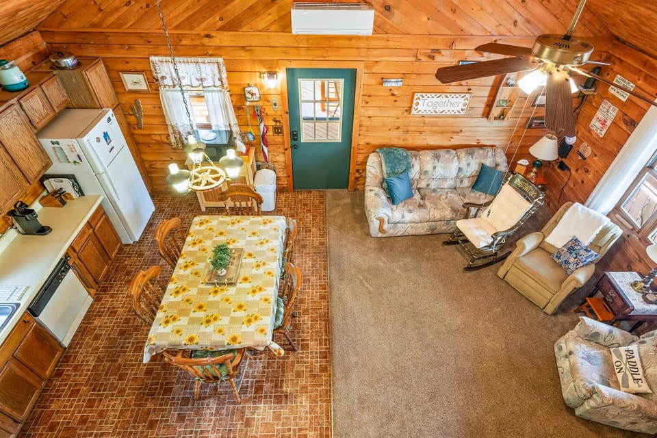 Gather around the large farmhouse table in this sunny kitchen with wood cabinetry and rustic decor. 🍽️🌻👨‍🍳