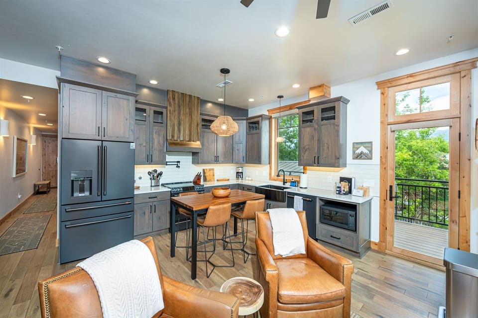 The modern, fully equipped kitchen has everything needed to prepare a memorable meal with your group | Main Level