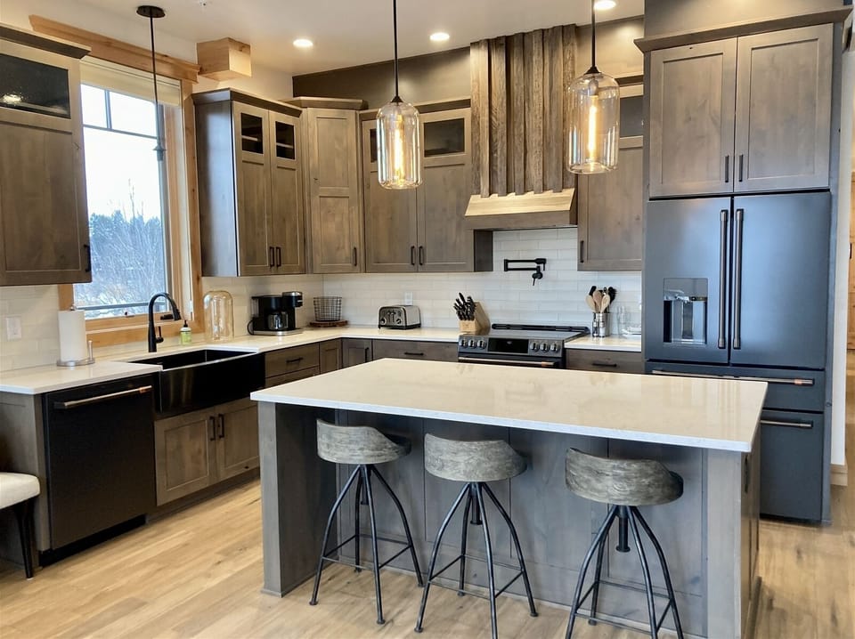 The kitchen features modern fixtures, high end appliances & island with seating | Main Level