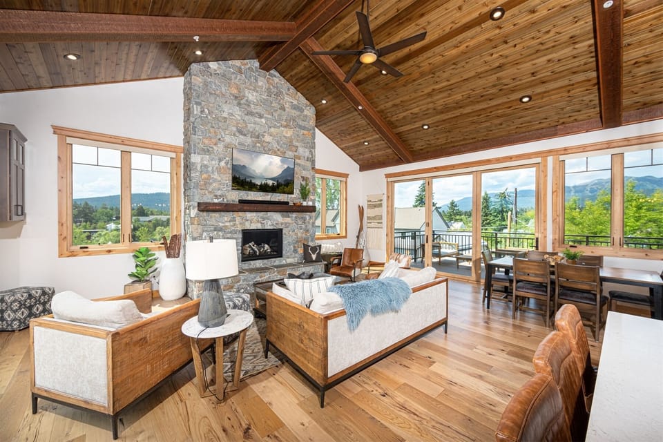 The beautiful wood-inlaid peaked ceiling beautifully frames the open concept living area of the home | Main Level