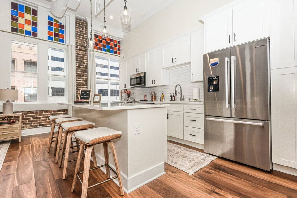 Kitchen: Bright and airy space with modern appliances and stunning stained glass windows!