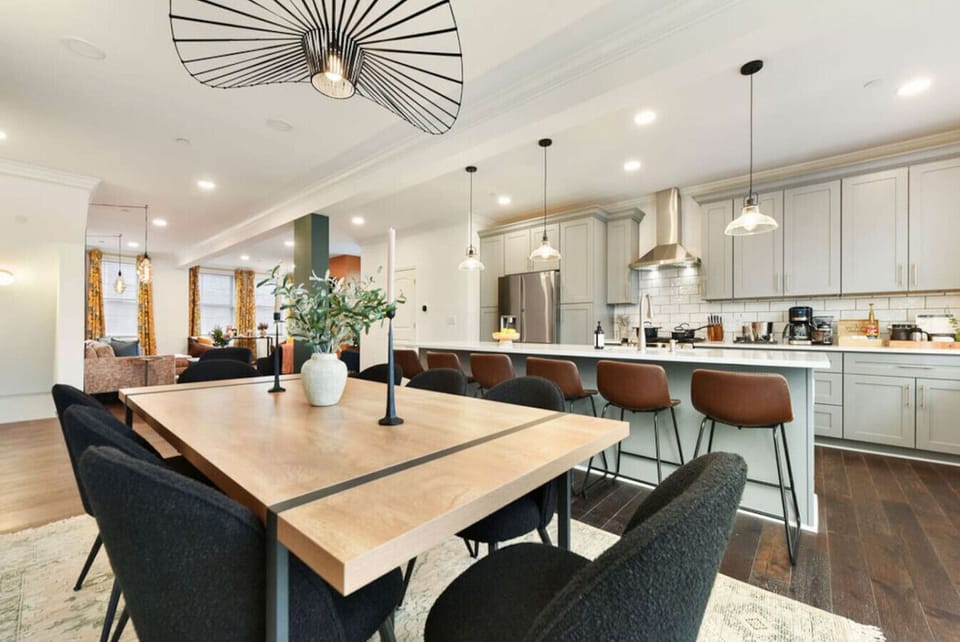 A bright, welcoming space combining the kitchen and living areas with modern fixtures and plenty of room for socializing.