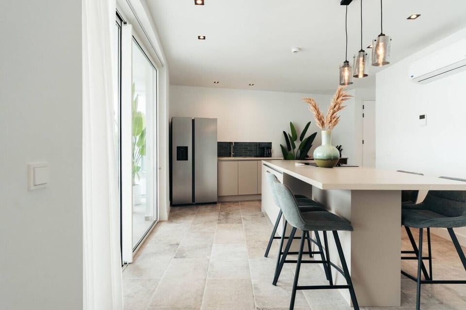Refresh and renew in this elegant second bathroom, where earthy stone tiles and a sleek, modern vanity create a calm, spa-like atmosphere for your stay.