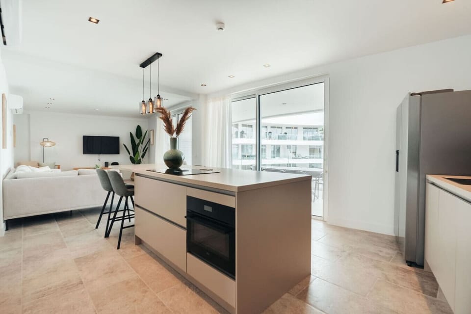 Cook with a view in this open-concept kitchen, where the sleek island and modern appliances are just steps away from the bright living area and sun-drenched terrace.