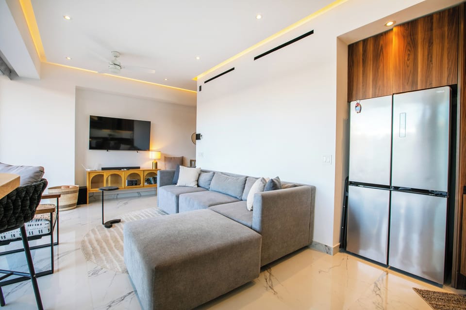 Living Room — Features a sectional sofa and a smart TV for your entertainment