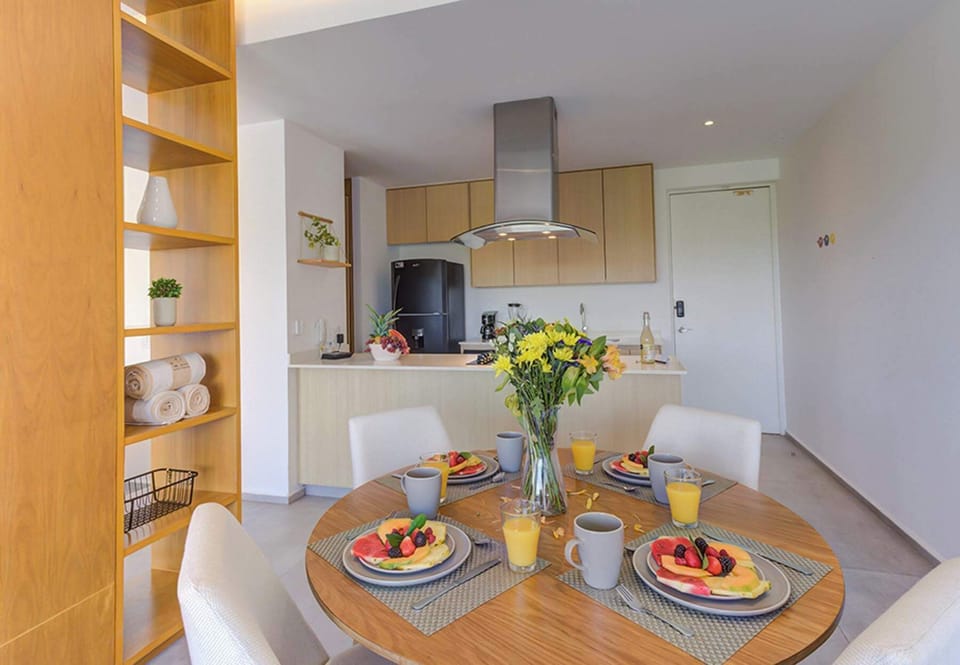 Intimate dining table set beside a modern open kitchen