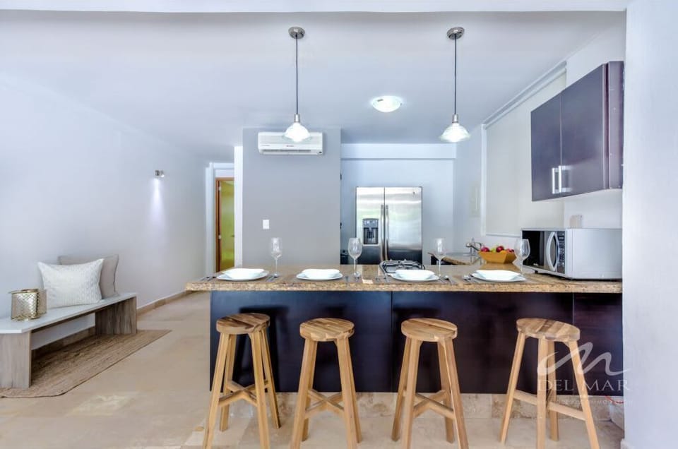 Modern kitchen w/ sleek island seating, pendant lights & open layout for easy cooking & gathering