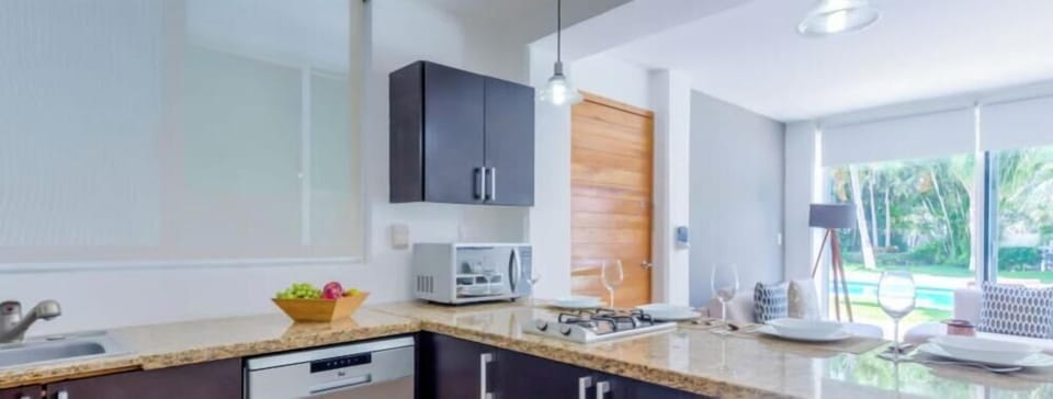 Spacious kitchen w/ sleek cabinetry, modern appliances & bright natural light