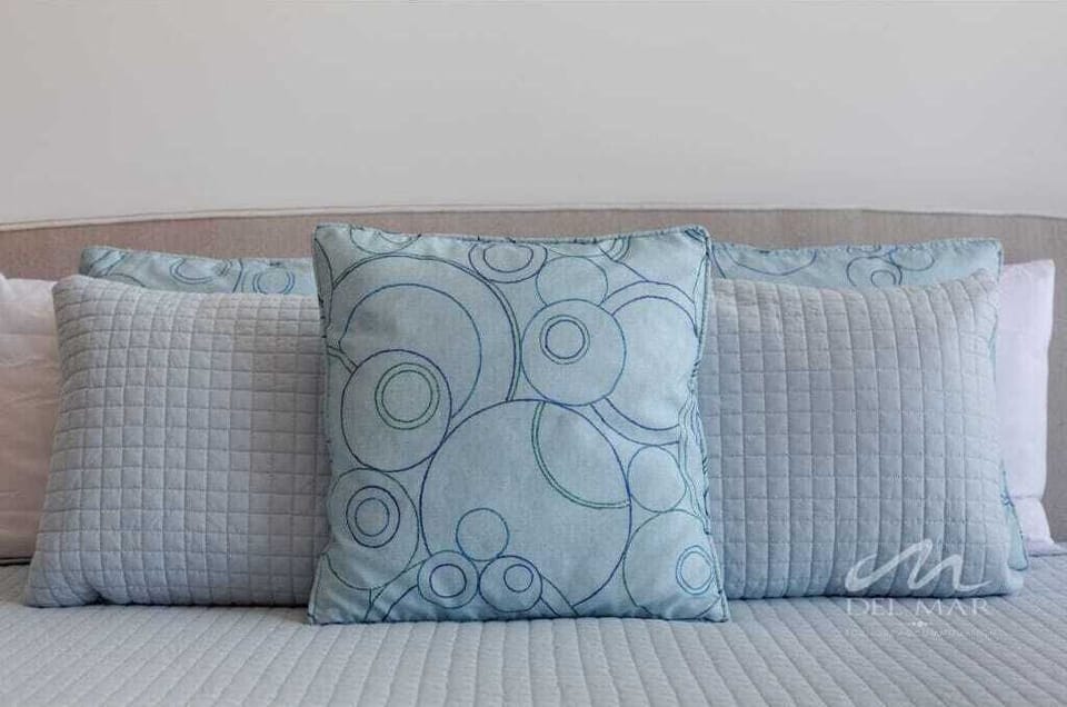 Close-up of plush bed pillows layered for a soft, inviting sleep space