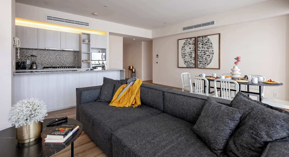 Airy living space w/ sectional sofa flowing into the open kitchen