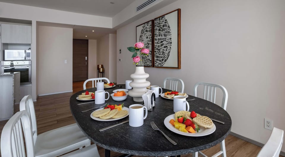 Elegant round dining table beautifully set for a sweet breakfast or relaxed brunch