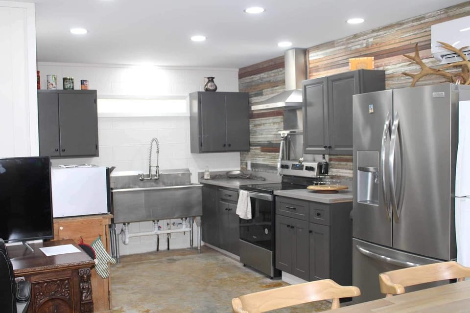 Downstairs kitchen, 3 bay stainless sink, stove/oven, microwave & Fridge w/icema