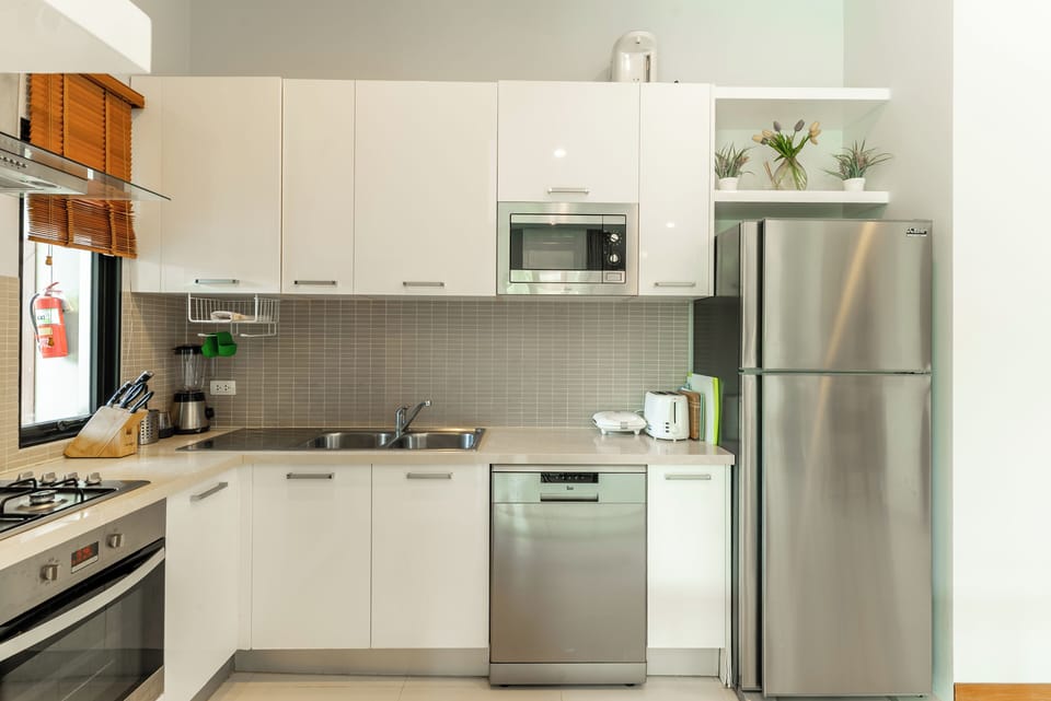 Family Villa | Private kitchen | Electric kettle, dining tables