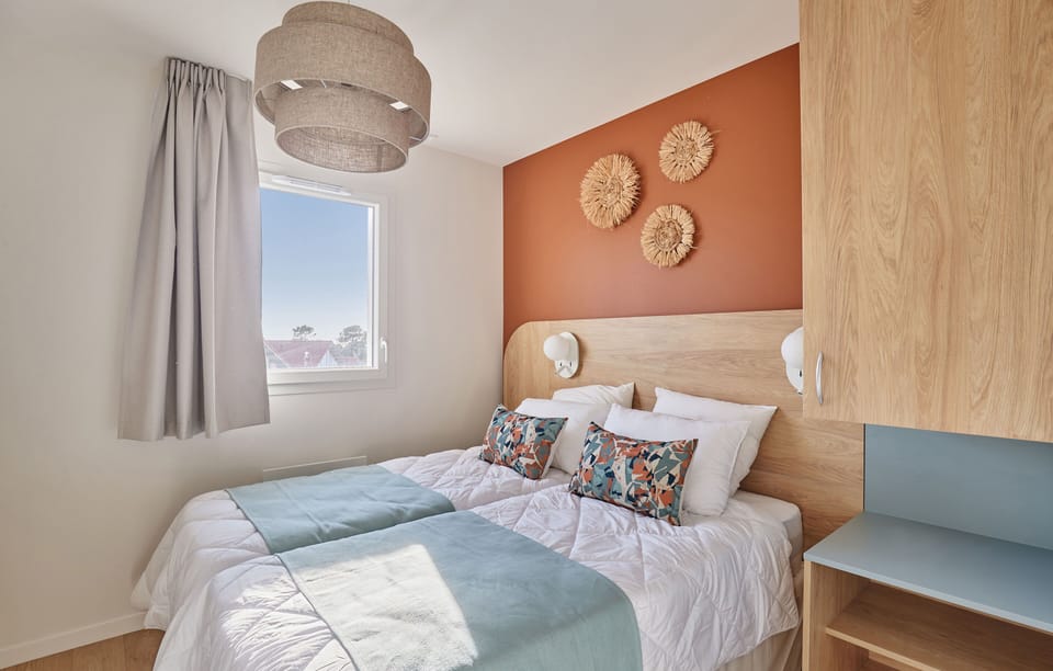 Dive into relaxation at the shared heated pool, nestled amid charming architecture and lush greenery, inviting you to unwind after a day at the beach.